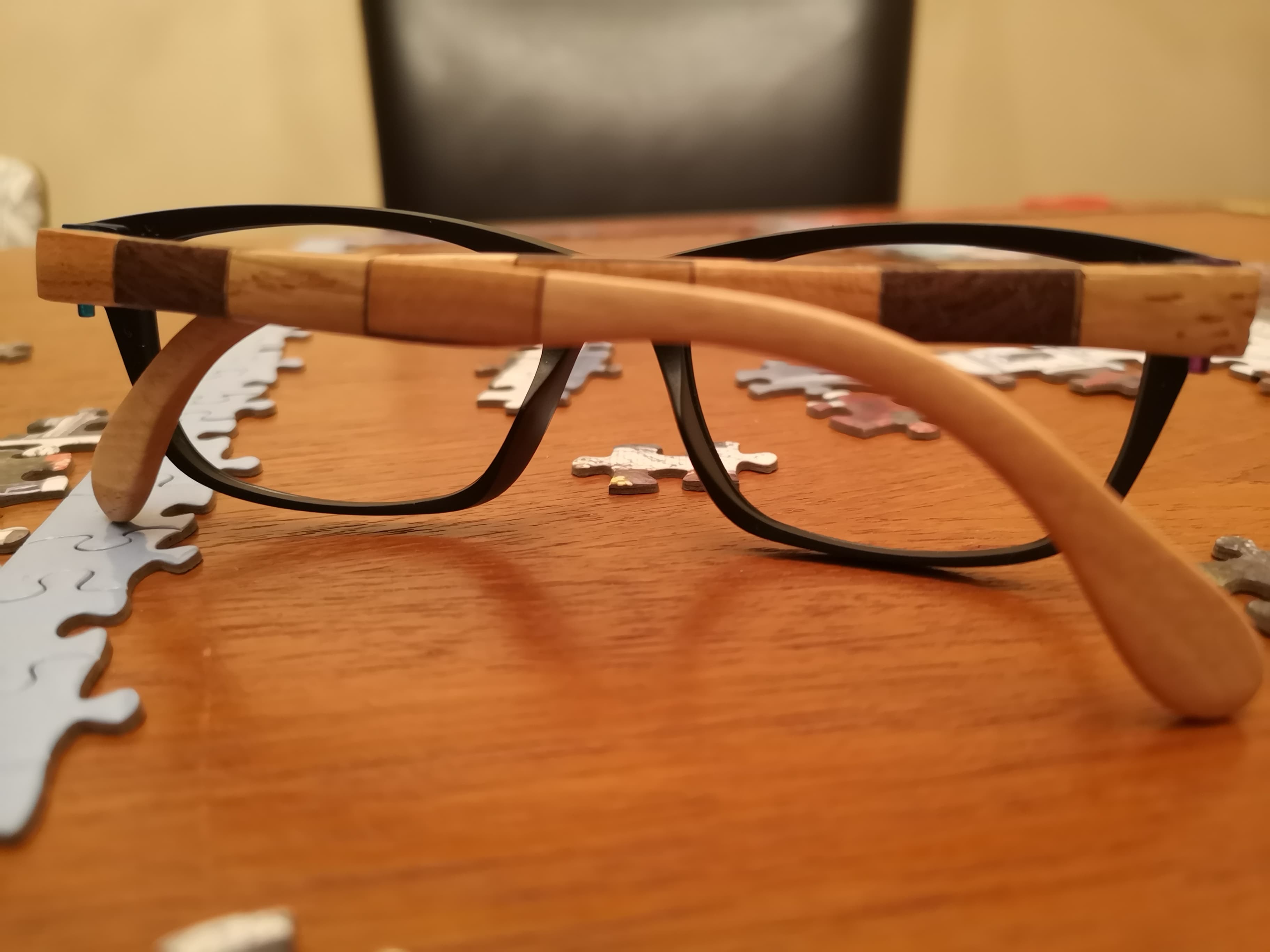 Black eyeglasses with patchwork temples made from alternating blocks of light and dark wood
