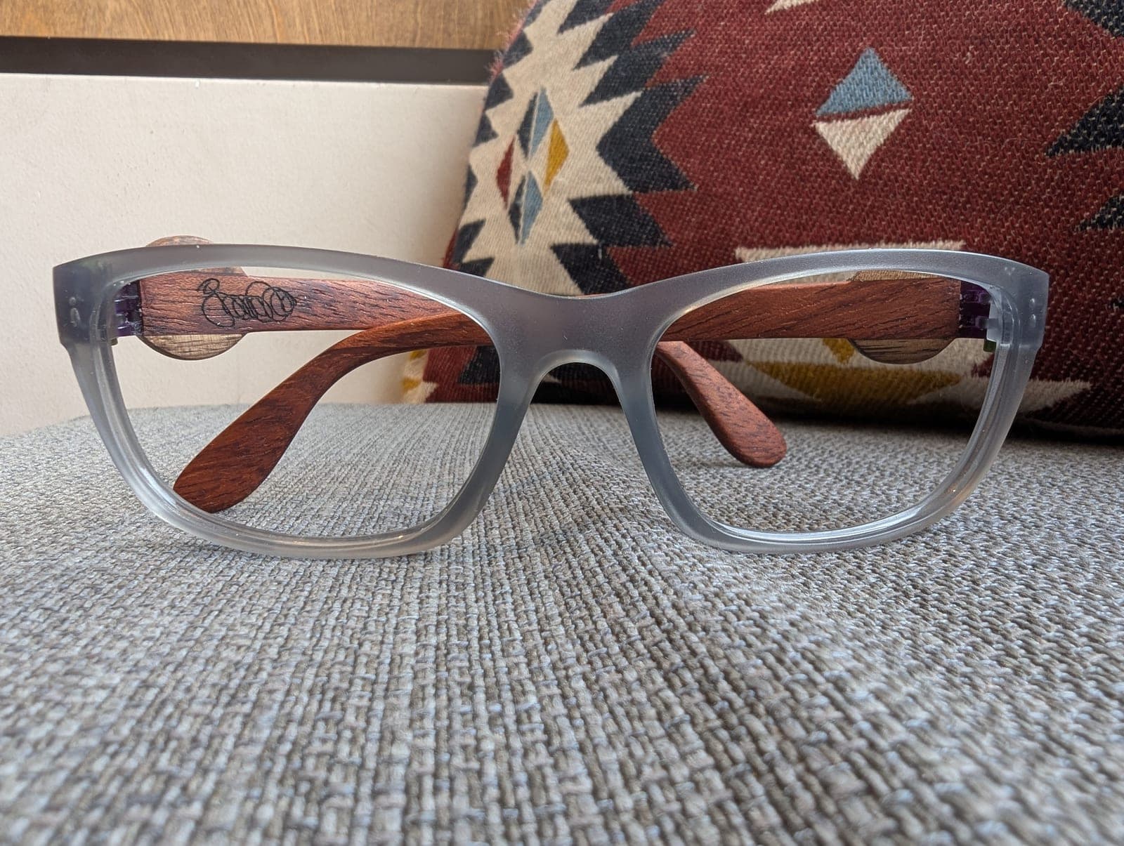 Front view of gray upcycled material eyeglasses with reddish mahogany wood temples