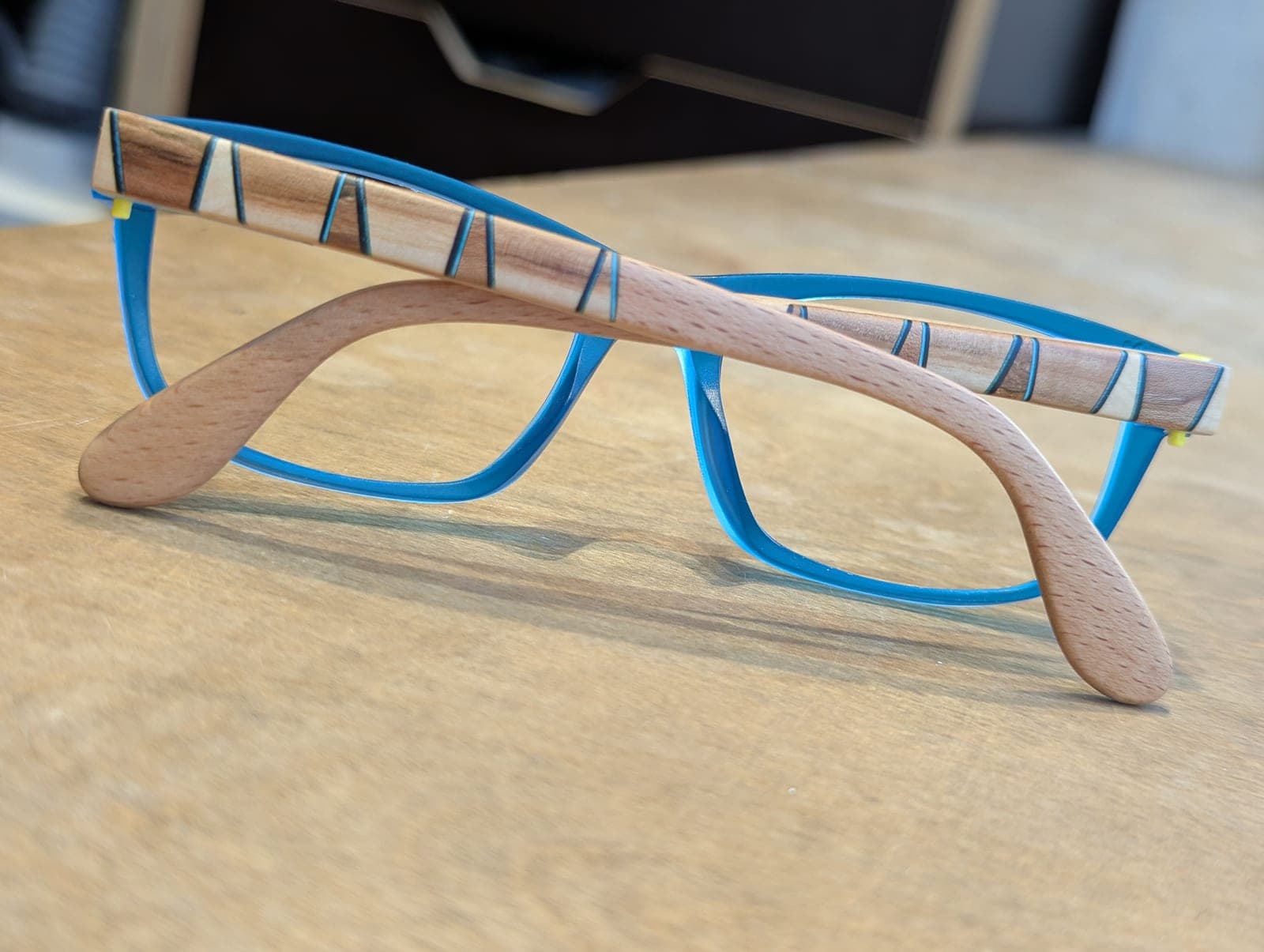 Sky blue upcycled material eyeglass frames with beech wood temples featuring a subtle striped inlay